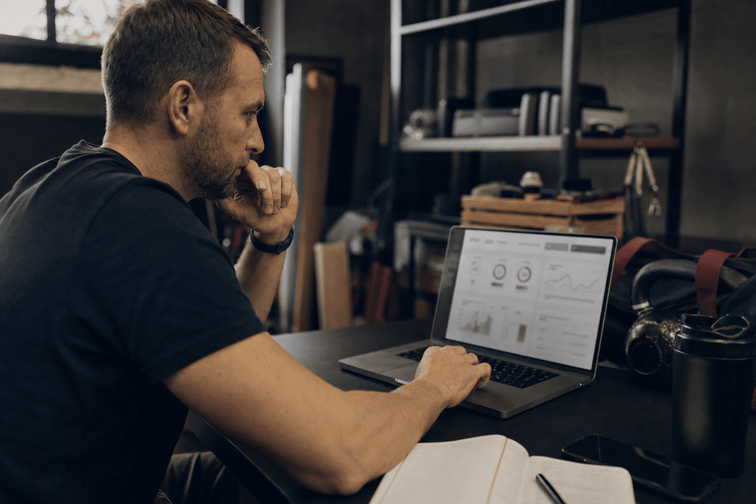 Operator reviewing a weekly dashboard near training gear